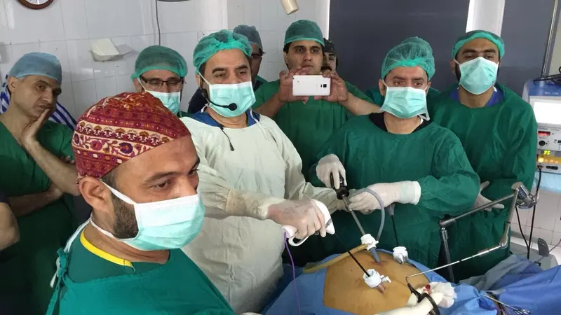 Dr. Siddiq operating laparoscopically while a surgical team observes